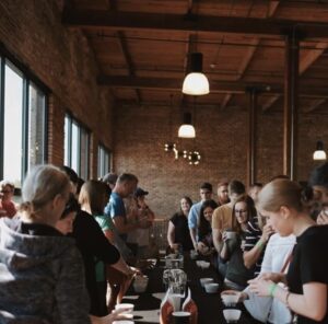 People cupping green coffee