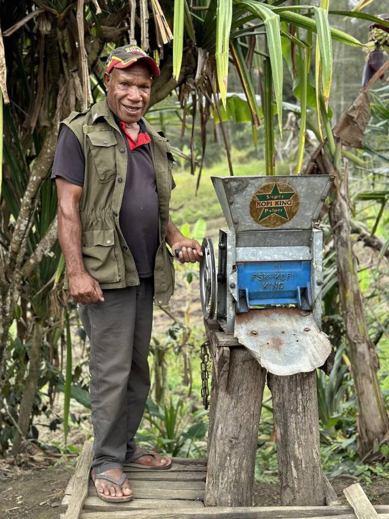Producer with a hand-cranked coffee pulper