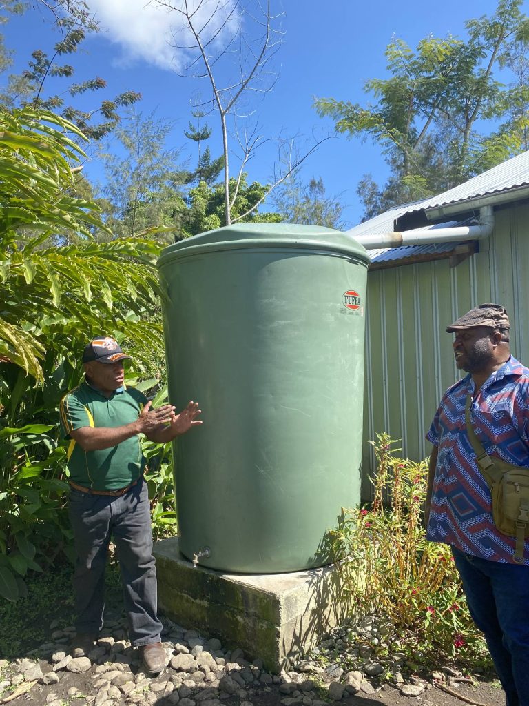 Water tank installation in a Papua New Guinea Highlands community